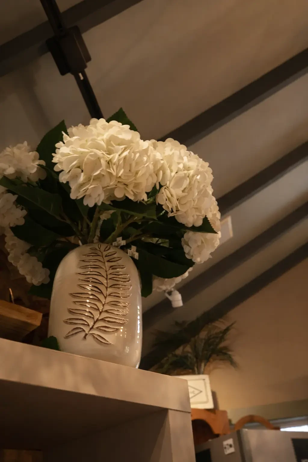 White hydrangeas and sculptural ceramic vase